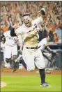  ?? Tony Gutierrez / Associated Press ?? Astros second baseman Jose Altuve celerates after scoring the winning run during the ninth inning of Game 2 of the ALCS.