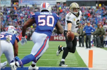  ?? Adrian Kraus / AP ?? Drew Brees (9) rushes in to score one of six touchdowns for New Orleans in its rout of Buffalo on Sunday.