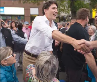  ?? The Canadian Press ?? Prime Minister Justin Trudeau shakes hands with people in Roberval Que.,