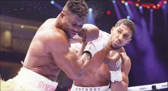  ?? ?? Anthony Joshua (right) took Francis Ngannou seriously and demolished him Photo by Richard Pelham/Getty Images