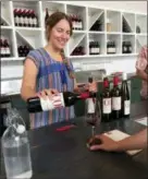  ??  ?? A server pouring a wine tasting at COR Cellars in Lyle, Wash., in the Columbia River Gorge.