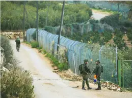  ?? (Karamallah Daher/Reuters) ?? IDF SOLDIERS patrol the border yesterday near the village of Kfar Kila, Lebanon.