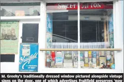  ?? (Photo: Katie Glavin) ?? M. Greehy’s traditiona­lly dressed window pictured alongside vintage signs on the door, one of which advertises Fruitfield preserves ‘now with patent twist-off lid’.