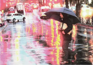  ?? PICTURE: CINDY WAXA/AFRICAN NEWS AGENCY/ ANA ?? DOWNPOUR: A man walked in Strand Street as Cape Town was blessed with some rain yesterday.