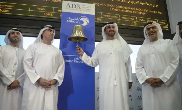  ??  ?? Dr Sultan Al Jaber, chief executive of Adnoc, rings in the start of trade for Adnoc Distributi­on at Abu Dhabi Securities Exchange yesterday Khushnum Bhandari for The National