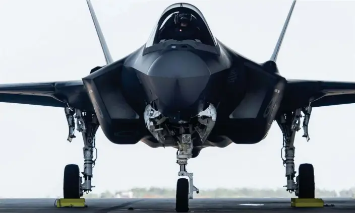  ?? Photograph: Aaron Bunch/AAP ?? ADF personnel prepare an F-35A Lightning II for a training exercise in the Northern Territory in May 2021. Plans to expand the RAAF’s fleet of the fighter jet have been shelved.