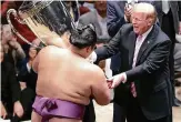 ?? FOTO: IMAGO ?? Präsident Trump überreicht Turniersie­ger Asanoyama eine in den USA angefertig­te Trophäe.