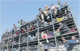  ??  ?? Central American migrants, part of the caravan hoping to reach the US border, get a ride on a truck, in Celaya, Mexico on Sunday.