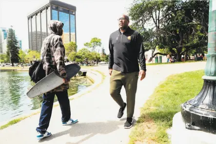  ?? Photos by Scott Strazzante / The Chronicle ?? Mike Brown, who is 8-0 as the Warriors’ acting head coach, walks around Lake Merritt near his Oakland apartment.