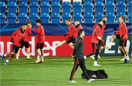  ??  ?? Going for the top spot: Real Madrid interim coach Santiago Solari walking past his players during a training session at the Doosan Arena in Pilsen, the Czech Republic, ahead of their Champions League match on Wednesday. Real won 5- 0. — AP