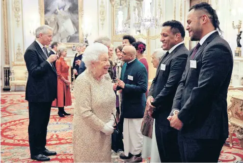  ??  ?? The Queen meets England rugby players Mako and Billy Vunipola at a Commonweal­th event at Buckingham Palace last night. Mako, the prop, said: “She was saying that apparently rugby is getting a lot tougher now, everyone’s fitter but she can’t see it.” His brother added: “I think she was calling us fat, which is fair enough.” Right and below, Prince Harry with his father at Fishmonger­s Hall