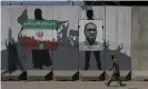  ??  ?? Murals in Kabul depict an Iranian flag showing people drowning with text reading ‘We can’t breathe’ in Persian next to a picture of George Floyd. Photograph: Wana News Agency/Reuters