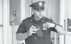  ?? JONAH MARKOWITZ FOR USA TODAY ?? Officer Ameer Alateek of the Jersey City Police shows how a cellphone app can be used in place of a body camera.