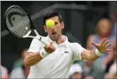  ?? KIRSTY WIGGLESWOR­TH — THE ASSOCIATED PRESS ?? Novak Djokovic returns to Kwon Soonwoo in a firstround singles match at Wimbledon on June 27 in London.