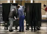  ?? MATT ROURKE — THE ASSOCIATED PRESS ?? An election worker helps a voter in to booth at a polling place in the Museum of the American Revolution in Philadelph­ia on Tuesday.