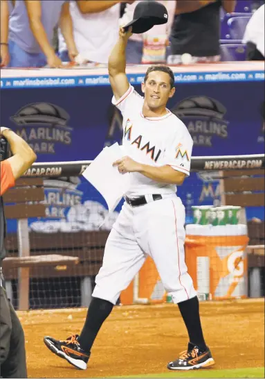  ?? Associated Press ?? Guilford-raised Adam Greenberg waves to the crowd during his one-day appearance with the Marlins in 2012.