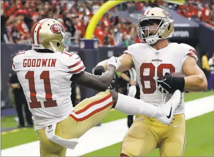  ?? DAVID J. PHILLIP — ASSOCIATED PRESS ?? The 49ers’ Garrett Celek celebrates his touchdown catch with Marquise Goodwin in the second half of the victory over the Texans.