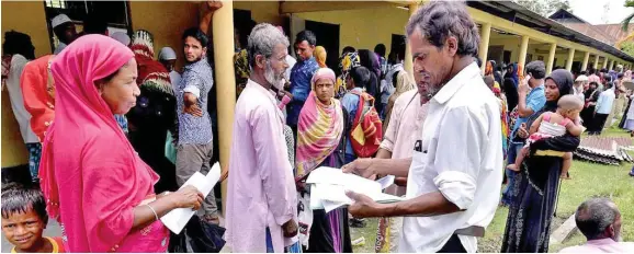  ??  ?? Villagers wait outside the National Register of Citizens centre to get their documents verified by government officials, at Mayong Village in Morigaon district, Assam.