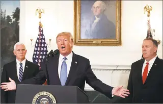  ?? Mark Wilson / Getty Images ?? President Donald Trump is flanked by Vice President Mike Pence, left, and Secretary of State Mike Pompeo while making a statement in the Diplomatic Room at the White House on Wednesday. Trump announced that the U.S. would be lifting all sanctions imposed on Turkey in response to their invasion of northern Syria.