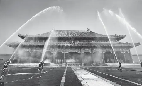  ?? PHOTOS BY LIU CHANG / FOR CHINA DAILY (1); JIANG DONG AND WANG KAIHAO / CHINA DAILY (2,3); BUDA MENDES / GETTY IMAGES (4) AND PROVIDED TO CHINA DAILY (5) ?? 11,2 and 5: Drills are staged frequently at the Palace Museum in Beijing, where a team is stationed by the east gate to keep watch for fire in turn 24 hours a day.3: Water tanks at the museum, used as “hydrants” in imperial times, are still full in the staff members’ areas.4: Fire sweeps through the National Museum of Brazil in Rio de Janeiro on Sept 3.