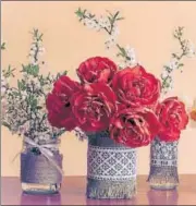  ?? PHOTO: ISTOCK ?? Spring flowers in glass jars decorated with crochet sheet