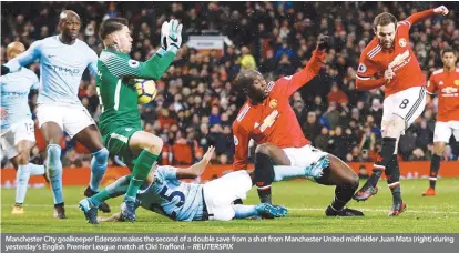 ??  ?? Manchester City goalkeeper Ederson makes the second of a double save from a shot from Manchester United midfielder Juan Mata (right) during yesterday’s English Premier League match at Old Trafford. – REUTERSPIX