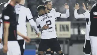  ??  ?? 0 Borna Barisic is congratula­ted after curling home a free-kick to put Rangers 3-0 up.