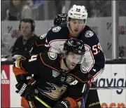  ?? ALEX GALLARDO — THE ASSOCIATED PRESS ?? Ducks center Adam Henrique, front, controls the puck past Blue Jackets right wing Yegor Chinakhov on Feb. 21.