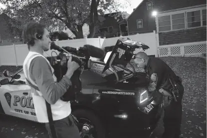  ?? Associated Press ?? A crew from the television program "Live PD," a reality show by the A&E Network, records an officer from the Bridgeport Police Department while on patrol Nov. 3, 2016, in Bridgeport, Conn.