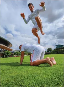  ??  ?? Novak Djokovic does a workout with his physio at Wimbledon, where he is favourite to retain his men’s singles crown