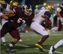  ?? TANIA BARRICKLO — DAILY FREEMAN ?? Kingston’s Shaheem Johnson tries to bring down Newburgh’s Terry Anderson during the Tigers’ defeat last Friday.