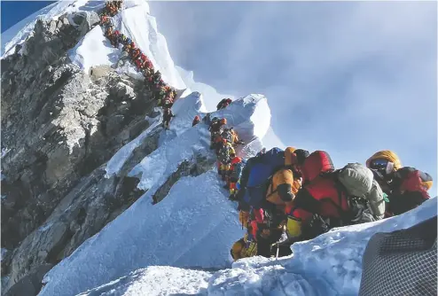  ?? AFP / GETTY IMAGES ?? As adventure tourism continues to increase in popularity, Mount Everest’s snowy slopes are dotted with brown.