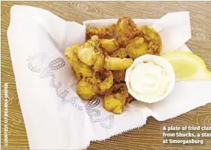  ??  ?? A plate of fried clam from Shucks, a stan at Smorgasbur­g