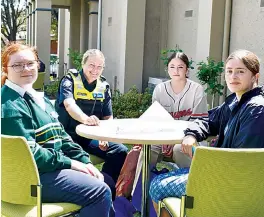  ?? ?? Left: Leading senior constable Paula Fowler talks about a career in policing with Maddelynn Edwards from MaristSion College, Ellia King from Chairo and Sofia Crivari from Kurnai College.