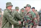  ??  ?? Pakistani military officials (R) meet with Russian troops upon their arrival at a Pakistan military base at an undisclose­d location. (Handout picture distribute­d through AFP)