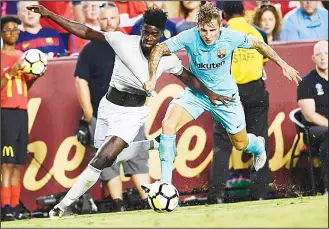  ??  ?? Manchester United’s defender Axel Tuanzebe and Barcelona’s defender Lucas Digne vie for the ball during their
Internatio­nal Champions Cup (ICC) football match on July 26 at the FedExField, in Landover, Maryland. (AFP)