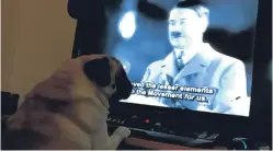  ??  ?? Buddha watching a video of Nazi leader Adolf Hitler.