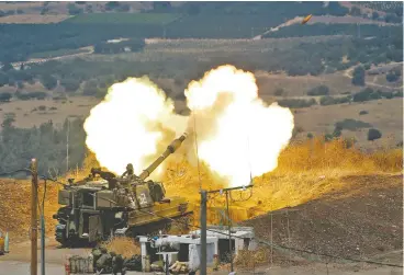  ?? JALAA MAREY / AFP VIA GETTY IMAGES ?? Israeli self-propelled howitzers fire toward Lebanon from a position near the northern Israeli town of Kiryat Shmona following rocket fire from inside Lebanon on Friday.