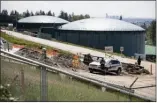  ?? Canadian Press file photo ?? A security guard stands nearby constructi­on workers at the Kinder Morgan Burnaby Terminal tank farm, the terminus point of the Trans Mountain pipeline, in Burnaby, B.C., on April 30.