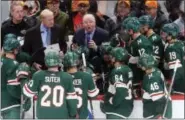  ?? JIM MONE — THE ASSOCIATED PRESS ?? Minnesota Wild coach Bruce Boudreau, center, talks to players Oct. 31 during a timeout in the team’s game against the Winnipeg Jets in St. Paul, Minn.