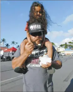  ??  ?? Son Moku gets a ride on Andrew Ponce’s shoulders while Dad enjoys Cream B hand-rolled ice cream at the Maui Sunday Market at Kahului Shopping Center. The pair and Moku’s mother, Sarah Freitas, arrived early to get the ice cream before people began lining up.