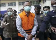  ?? ?? Indonesian Maritime Affairs and Fisheries Minister Edhy Prabowo, center, is escorted by security officers after a news conference at the Indonesian Corruption Eradicatio­n Commission (KPK) office in Jakarta, Indonesia, Nov. 26, 2020.