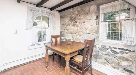  ??  ?? The ground-floor kitchen has original brick floors, a beamed ceiling and exposed stone walls.