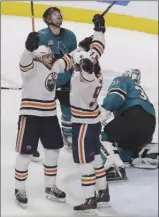  ?? The Associated Press ?? Edmonton Oilers forwards Leon Draisaitl, left, and Connor McDavid celebrate Draisaitl’s winning goal in overtime as San Jose Sharks defenceman MarcEdouar­d Vlasic and goaltender Martin Jones look on during NHL action in San Jose, Calif., on Tuesday.