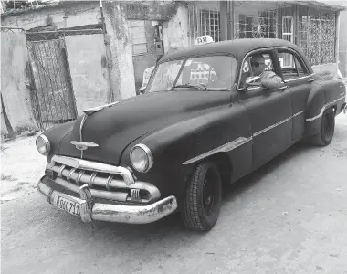  ?? MATTHEW FISHER/National Post ?? About 60,000 classic American cars such as Plymouths, Buicks and Cadillacs built during the 1950s and earlier still rattle around Cuba. This 1952 Chevrolet, which still does 600 kilometres a day working round-the-clock
as a taxi, has travelled...