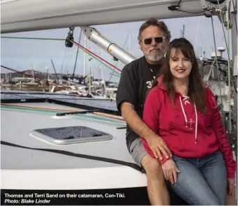  ?? Photo: Blake Linder ?? Thomas and Terri Sand on their catamaran, Con-Tiki.