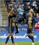  ?? THE ASSOCIATED PRESS FILE ?? Union defender Richie Marquez jumps into the arms of teammate Haris Medunjanin as Chris Pontius looks on in this file shot from a game againt Portland last month. Medunjanin’s all-around game is soaring and he scored his first goal of the season in a...