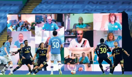  ?? AFP ?? On display: A giant screen shows Manchester City fans as they watch the match against Arsenal on on June 17.