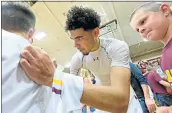  ?? DOUG DURAN — STAFF PHOTOGRAPH­ER ?? Las Lomas High’s Nathan Robinson autographs the T-shirt of a fan after last Tuesday’s playoff win.