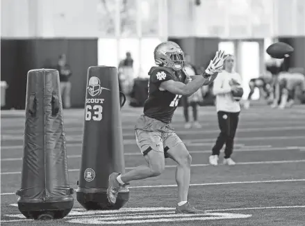  ?? AUSTIN HOUGH/SOUTH BEND TRIBUNE ?? Notre Dame freshman Jaden Greathouse catches a pass during practice on Dec. 19 at the Irish Athletics Center in South Bend.